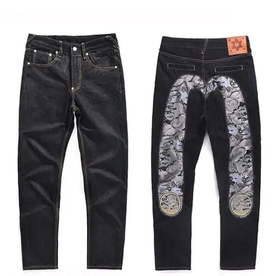 Dark denim jeans shown twice on white, plain on the left and with a pale paisley panel down the leg on the right